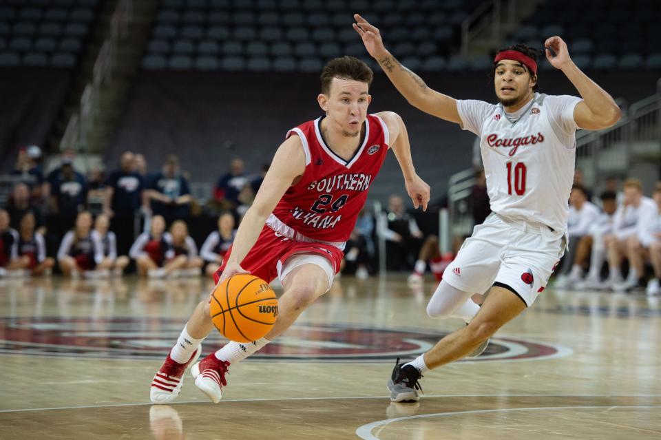 Southern Indiana’s Jack Campion (24) drives past SIU-Edwardsville’s Jalen Hodge (10) during the first round of the Ohio Valley Conference at Ford Center in Evansville, Ind., on Wednesday, March 1, 2023.