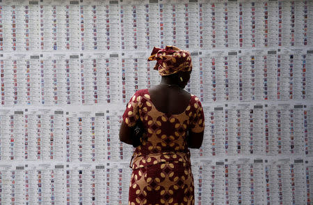 A woman looks for her name on the electoral list at a polling station of Lafiabougou in Bamako, Mali, July 23, 2018. REUTERS/Luc Gnago