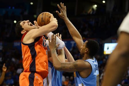 Dec 27, 2015; Oklahoma City, OK, USA; Oklahoma City Thunder center Enes Kanter (11) is fouled on a shot attempt by Denver Nuggets forward Darrell Arthur (00) during the fourth quarter at Chesapeake Energy Arena. Mandatory Credit: Mark D. Smith-USA TODAY Sports
