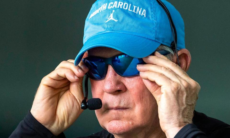 North Carolina coach Mack Brown slips on his sunglasses as he heads outside during the first day of practice on Wednesday, August 2, 2023 in Chapel Hill, N.C.