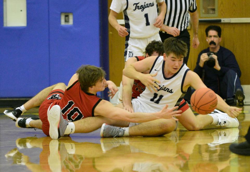 Colton Cornwell of Chambersburg hustles for a loose ball against Cody Ryan (10) of Warwick.