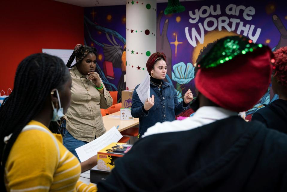 Detroit residents DeAndra Matthews left, and Chella Bluth-Rosenberg, both 24, coordinate a gift wrapping activity with youth volunteers at the Detroit Phoenix Center, an organization that provides support for youths facing economic, social, and educational challenges, in Detroit on Dec. 13, 2022.