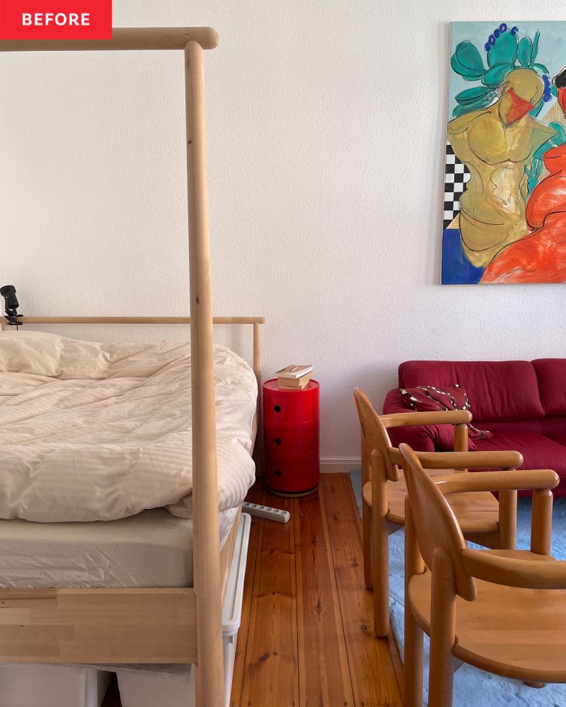 Wooden bed frame in studio apartment.