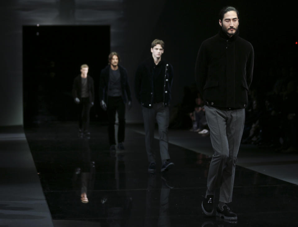 Models wear creations for Giorgio Armani men's Fall-Winter 2014 collection, part of the Milan Fashion Week, unveiled in Milan, Italy, Tuesday, Jan.14, 2014. (AP Photo/Luca Bruno)