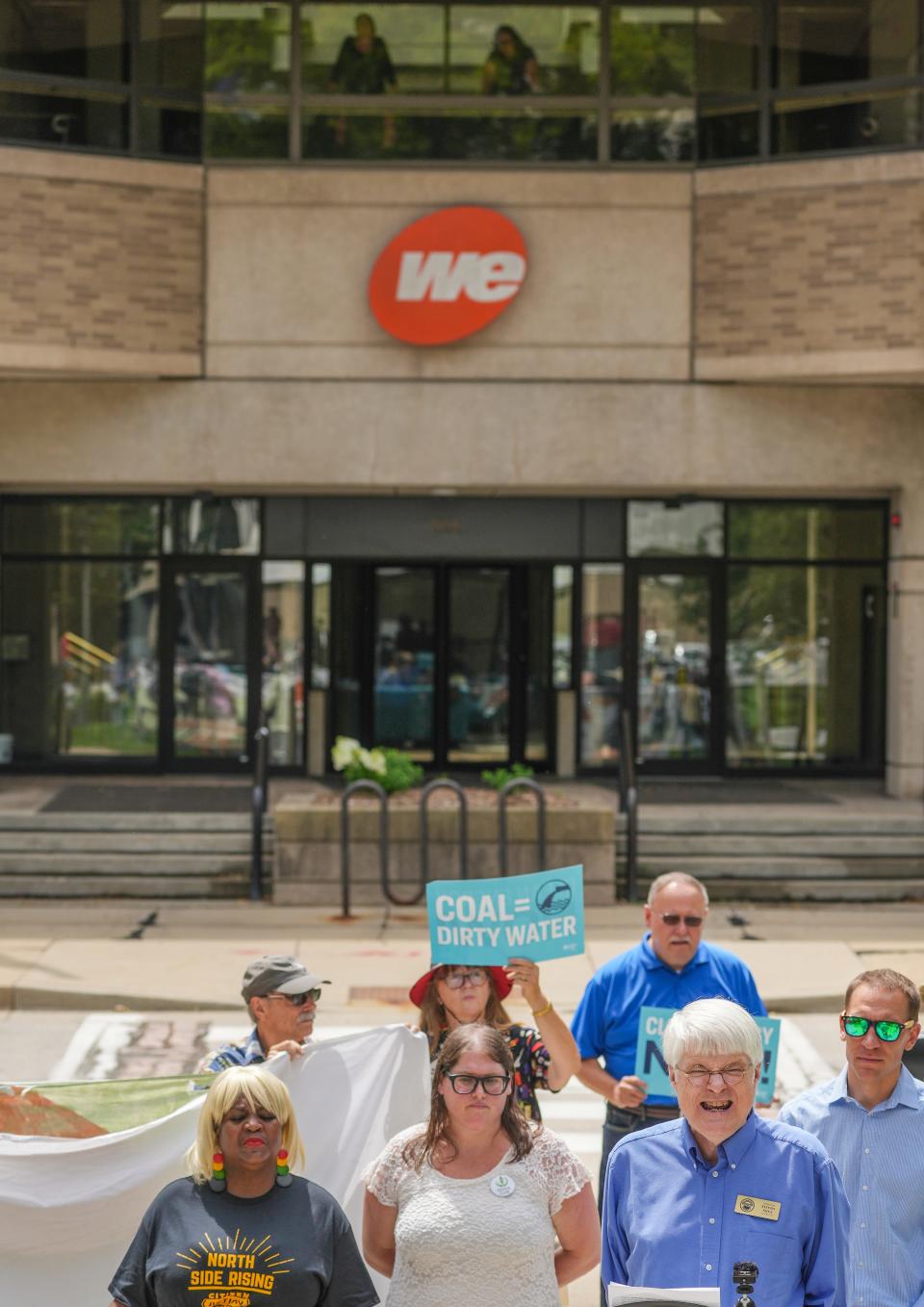 Milwaukee County Board Supervisor Steven Shea speaks as employees watch from above during a protest against We Energies' plans to delay the closing of the power plant in Oak Creek.