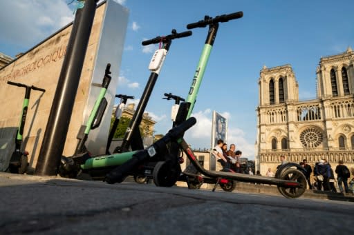 Electric scooters parked in front of Notre-Dame cathedral in Paris