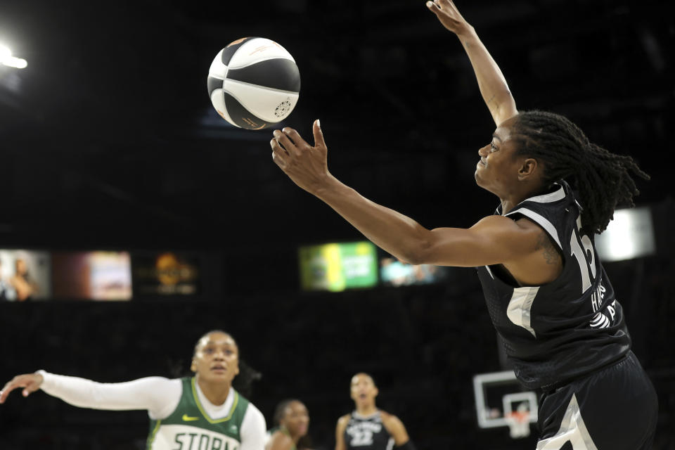 Las Vegas Aces guard Tiffany Hayes (15) tries to keep the ball in play as Seattle Storm guard Victoria Vivians watches during the first half of a WNBA basketball game in Las Vegas on Friday, June 7, 2024. (Steve Marcus/Las Vegas Sun via AP)