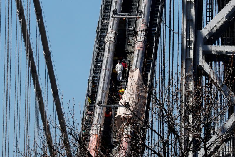 Construction workers on George Washington Bridge duering reconstruction in New York