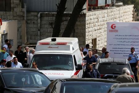 An ambulance transports the body of Jordanian writer Nahed Hattar to a medical facility, after he was shot, in Amman, Jordan, September 25, 2016. REUTERS/Muhammad Hamed