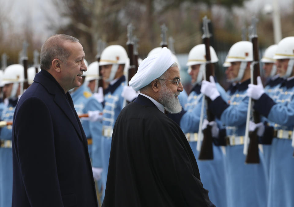 Turkey’s President Recep Tayyip Erdogan, and Iran’s President Hassan Rouhani review an honour guard