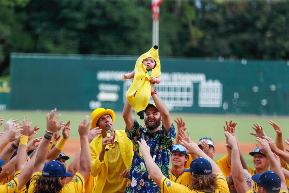 Savannah Bananas players gather around the Banana baby before the start of the CPL championship game on Aug, 5, 2022 at Grayson Stadium. "Banana Baby" is one of the pregame traditions that the team performs at home games but is unable to feature in road contests.