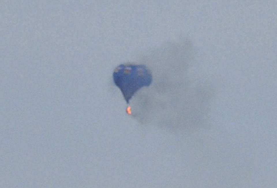 A hot air balloon on fire is pictured north of Richmond, Virginia, May 9, 2014, in this handout photo courtesy of Lynn Shultz. At least one person died and two were missing after the hot air balloon hit a power line and caught fire over Virginia during a festival, police said on Saturday. Authorities said they had found the remains of one person, and were continuing to search for the others missing after the Friday evening accident 30 miles north of Richmond. Mandatory Credit. REUTERS/Lynn Shultz/Handout via Reuters (UNITED STATES - Tags: DISASTER SOCIETY TRANSPORT) ATTENTION EDITORS - NO SALES. NO ARCHIVES. FOR EDITORIAL USE ONLY. NOT FOR SALE FOR MARKETING OR ADVERTISING CAMPAIGNS. THIS PICTURE WAS PROVIDED BY A THIRD PARTY. REUTERS IS UNABLE TO INDEPENDENTLY VERIFY THE AUTHENTICITY, CONTENT, LOCATION OR DATE OF THIS IMAGE. THIS PICTURE WAS PROCESSED BY REUTERS TO ENHANCE QUALITY. AN UNPROCESSED VERSION WILL BE PROVIDED SEPARATELY. MANDATORY CREDIT