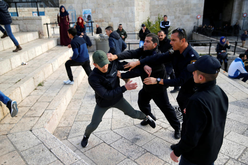 Israeli policemen scuffle with a Palestinian man during a protest near Damascus Gate in Jerusalem's Old City December 7, 2017.&nbsp;