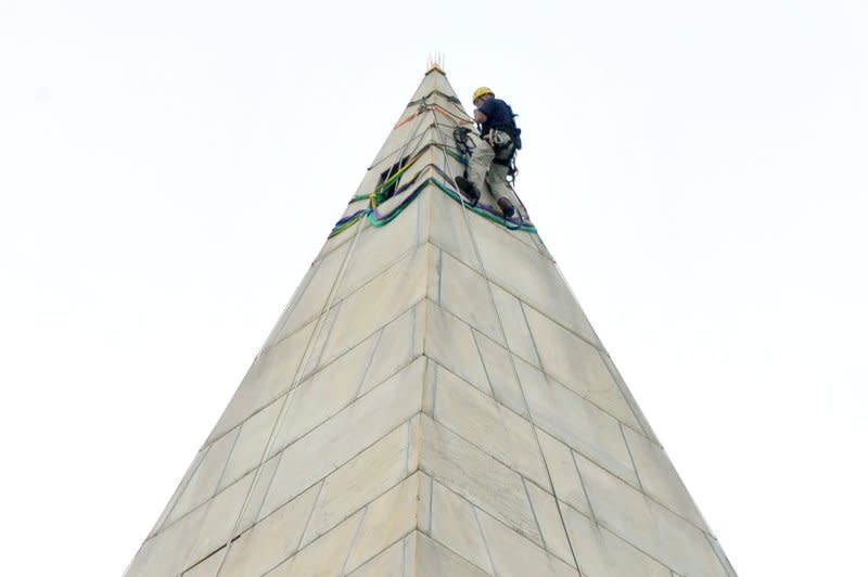A worker installs rigging as inspection begins to check the Washington Monument for additional damage following the August 23, 2011, earthquake in Washington, D.C., on September 27, 2011. File Photo by Kevin Dietsch/UPI