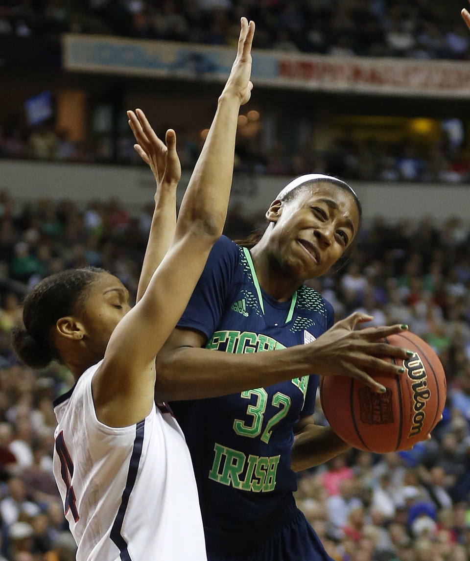 Notre Dame guard Jewell Loyd (32) collides into Connecticut guard Moriah Jefferson (4) during the first half of the championship game in the Final Four of the NCAA women's college basketball tournament, Tuesday, April 8, 2014, in Nashville, Tenn. (AP Photo/John Bazemore)
