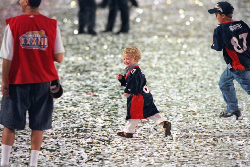 Christian McCaffrey (center) and Mac McCaffrey (right), sons of Denver Broncos Ed McCaffrey, running through confetti on the field after the Broncos' win at the 1999 Super Bowl.<p>Robert Beck /Sports Illustrated via Getty Images</p>