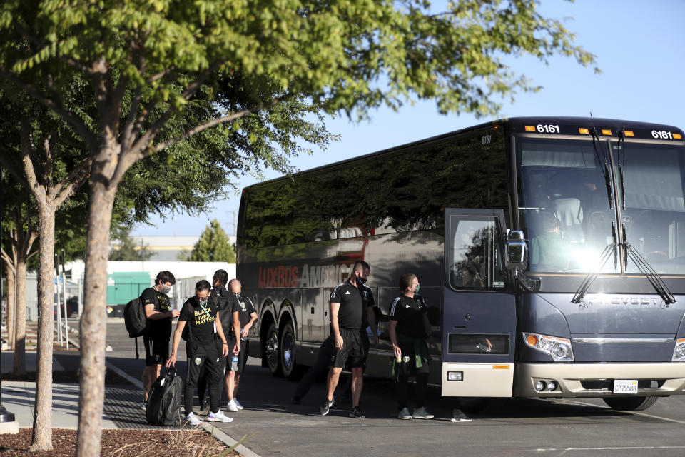 Members of the Portland Timbers prepare to depart the stadium where the team had been scheduled to play the San Jose Earthquakes in an MLS soccer match in San Jose, Calif., Wednesday, Aug. 26, 2020. Major League Soccer players boycotted five games Wednesday night in a collective statement against racial injustice. The players' actions came after all three NBA playoff games were called off in a protest over the police shooting of Jacob Blake in Wisconsin on Sunday night.