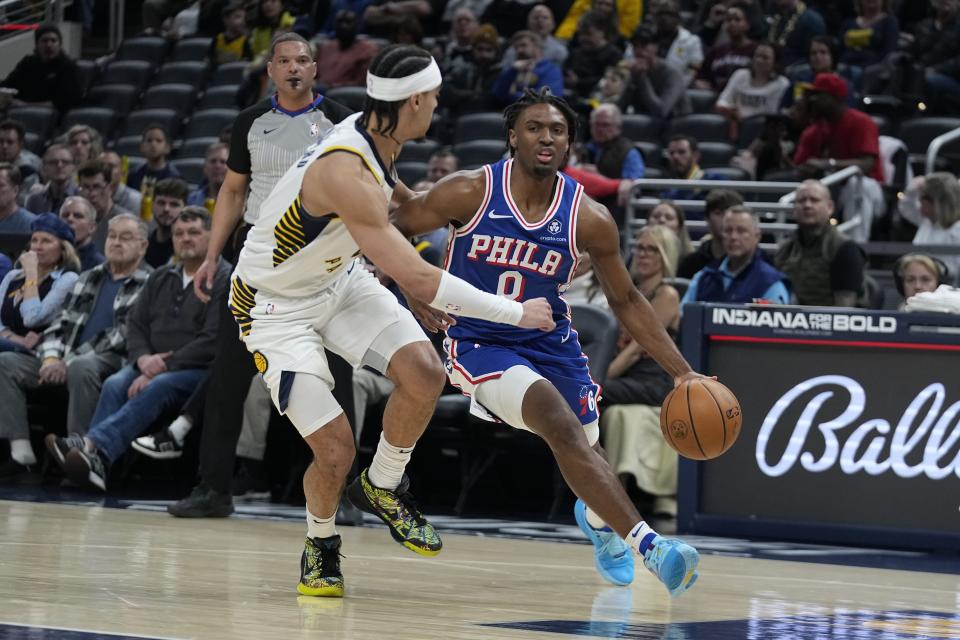 Philadelphia 76ers' Tyrese Maxey (0) goes to the basket against Indiana Pacers' Andrew Nembhard during the first half of an NBA basketball game Thursday, Jan. 25, 2024, in Indianapolis. (AP Photo/Darron Cummings)