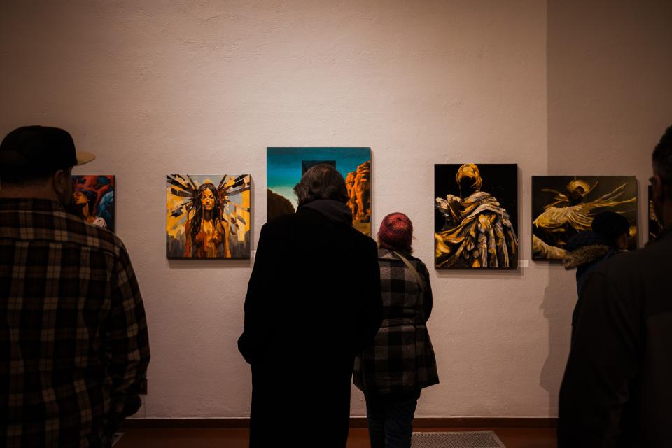Patrons gather to view the Price Tower's newest art exhibit, Jon Lindblom's 'Angels of Pandora: An AI/Human Collaboration,' during its Jan. 19 opening.