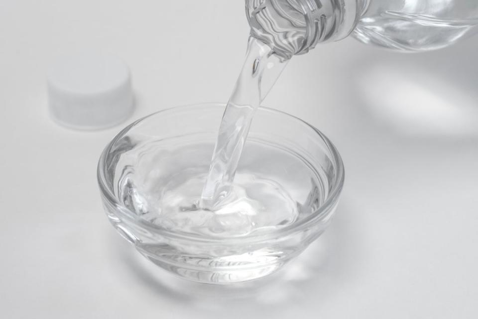 White vinegar being poured into small bowl