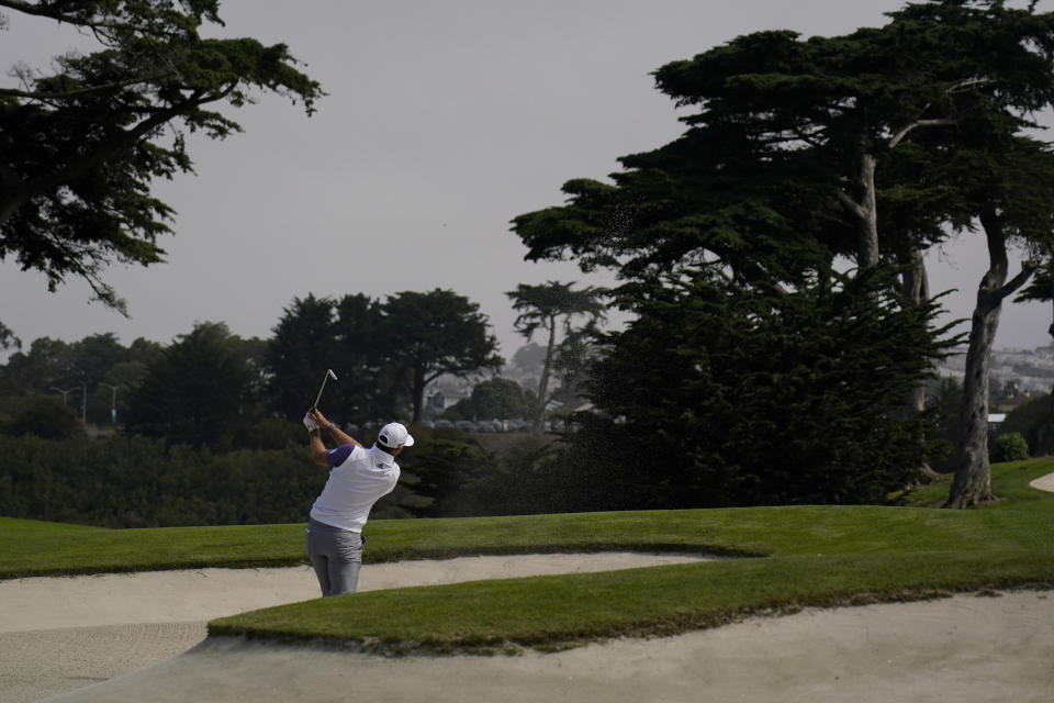 Dustin Johnson hits from the bunker on the 18th hole during the first round of the PGA Championship golf tournament at TPC Harding Park Thursday, Aug. 6, 2020, in San Francisco. (AP Photo/Jeff Chiu)
