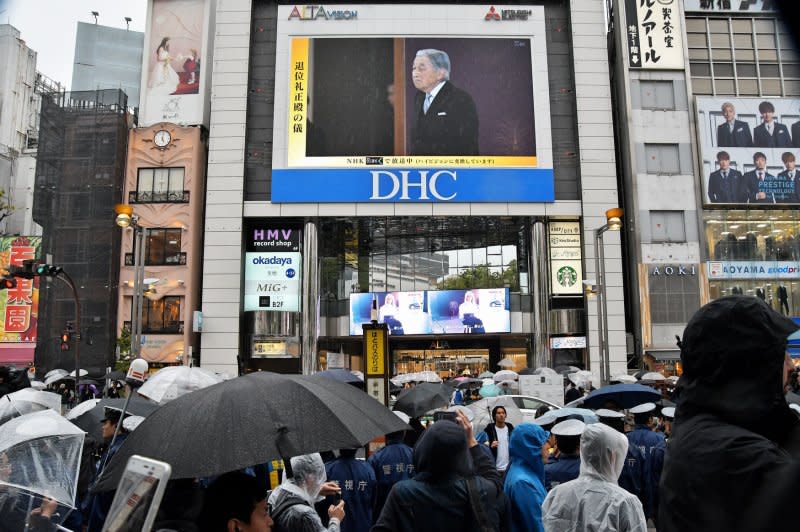 People watch a live broadcast of Emperor Akihito's abdication ceremony on the screen near the Shinjuku station in Tokyo on April 30, 2019. File Photo by Keizo Mori/UPI