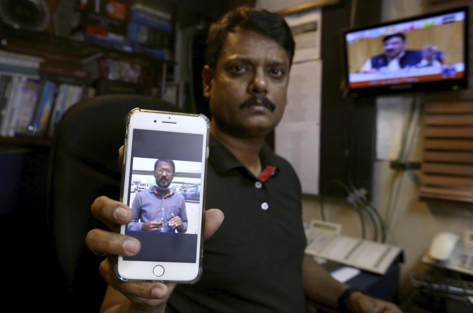 Fahim Siddiqi, Karachi bureau chief of Geo News television, shows the picture of missing colleague Ali Imran Syed, at his office in Karachi, Pakistan, Saturday, Oct. 24, 2020. The Geo bureau chief said Saturday that police registered the journalist’s disappearance as an “abduction” case without naming suspects. (AP Photo/Fareed Khan)