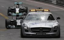 Mercedes Formula One driver Nico Rosberg of Germany (C) and his teammate Mercedes Formula One driver Lewis Hamilton of Britain (back) follow a safety car during the second lap of the Monaco F1 Grand Prix in Monaco May 25, 2014. REUTERS/Max Rossi (MONACO - Tags: SPORT MOTORSPORT F1)