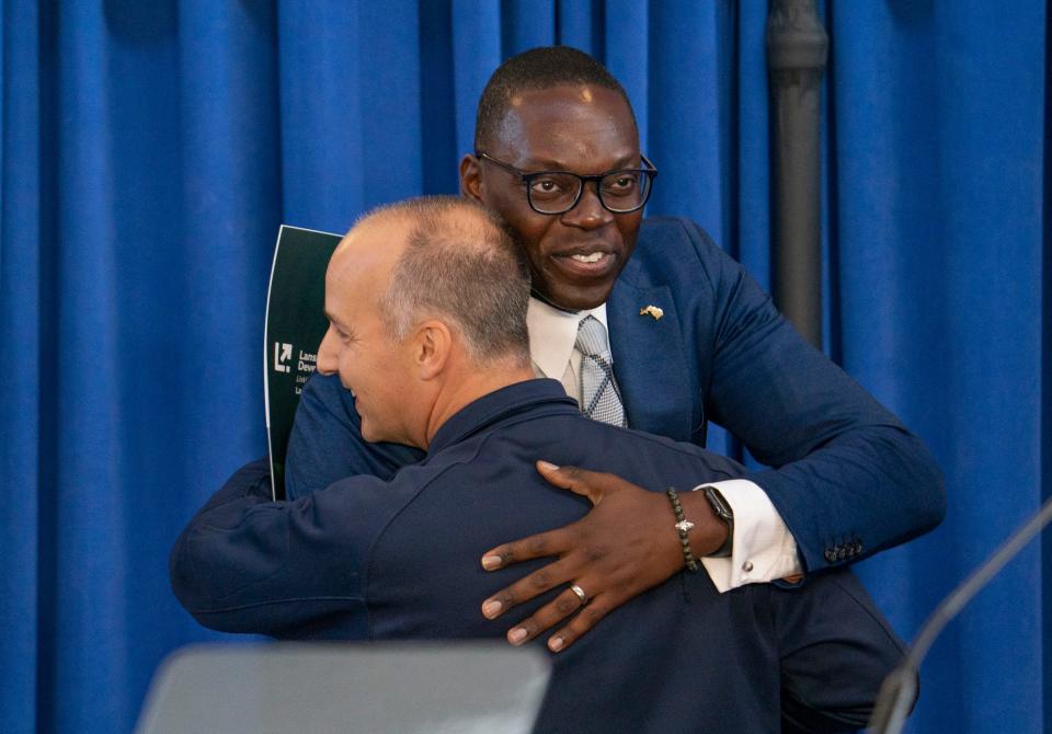 Lansing Mayor Andy Schor, left, gives a big hug to Michigan Lt. Gov. Garlin Gilchrist before Michigan Gov. Gretchen Whitmer delivers her "What's Next" Address that outlines her legislative priorities for the fall at the Lansing Shuffle in Lansing on Wednesday, Aug. 30, 2023.