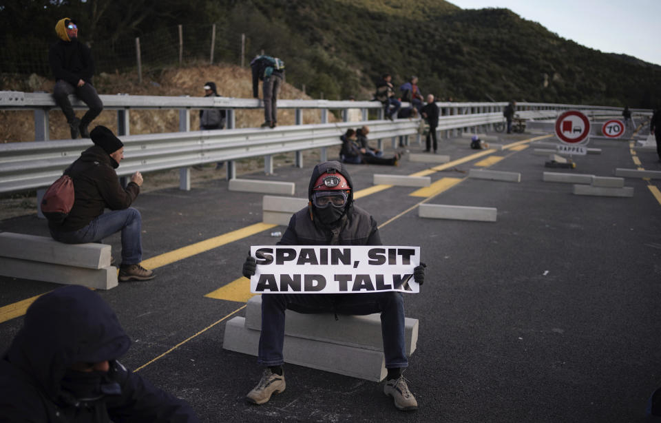 Pro-Catalan independence demonstrators block a major highway border pass between France and Spain near La Jonquera, Girona, Monday, Nov. 11, 2019. Protesters following a call to action by a secretive pro-Catalan independence group have closed off both sides of the AP7 highway at the major transportation hub of La Jonquera between France and Spain. (AP Photo/Felipe Dana)