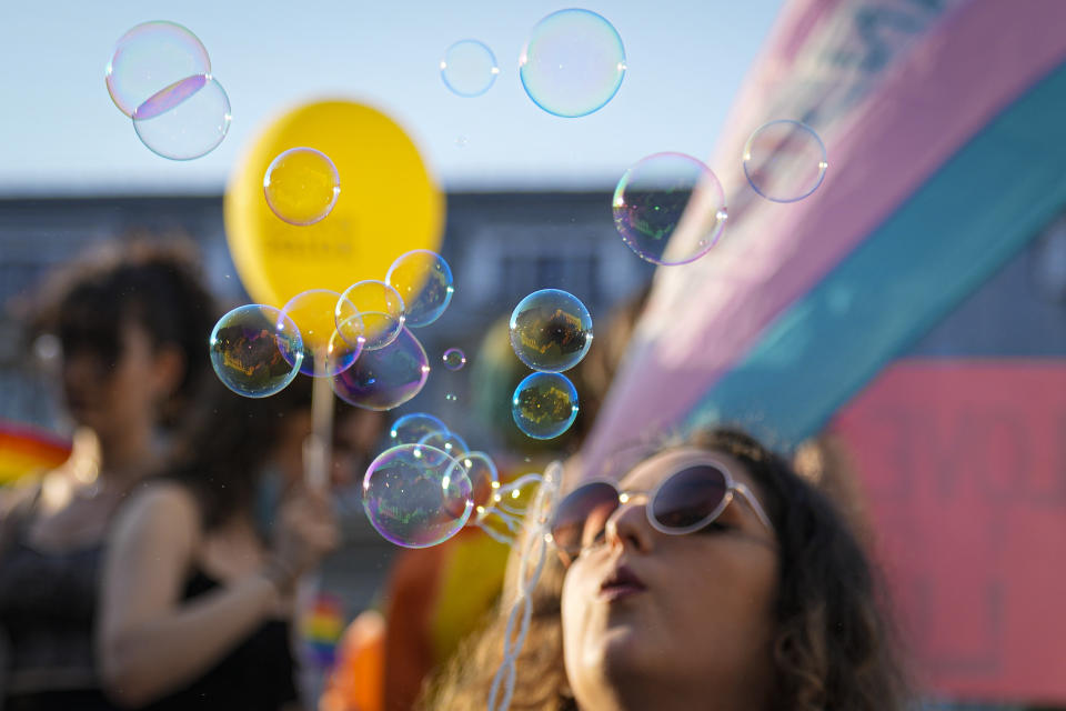 Buildings are reflected in soap balloons during the Bucharest Pride 2021 in Bucharest, Romania, Saturday, Aug. 14, 2021. The 20th anniversary of the abolishment of Article 200, which authorized prison sentences of up to five years for same-sex relations, was one cause for celebration during the gay pride parade and festival held in Romania's capital this month. People danced, waved rainbow flags and watched performances at Bucharest Pride 2021, an event that would have been unimaginable a generation earlier. (AP Photo/Vadim Ghirda)