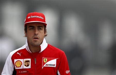 Ferrari Formula One driver Fernando Alonso of Spain arrives for a news conference ahead of the Chinese F1 Grand Prix at the Shanghai International Circuit April 17, 2014. REUTERS/Carlos Barria