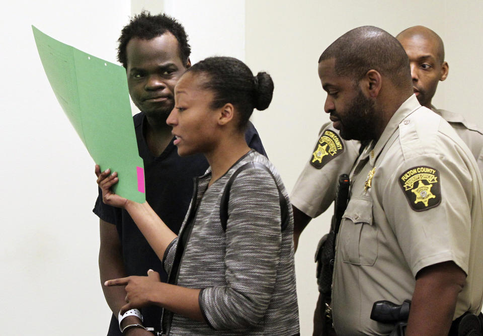 Basil Eleby is escorted by his public defender and two Fulton County Sheriff's office officers into the court room at the Fulton County Jail in Atlanta on Saturday, April 1, 2017. Eleby, accused of starting a raging fire that collapsed a portion of Interstate 85 a few miles north of downtown Atlanta was charged with arson. The first-degree arson charge was added to a first-degree criminal damage to property charge Eleby already faced in connection with the fire Thursday evening that caused a heavily traveled overpass to disintegrate. Total bond was set at $200,000. (Henry P. Taylor/Atlanta Journal-Constitution via AP, Pool)