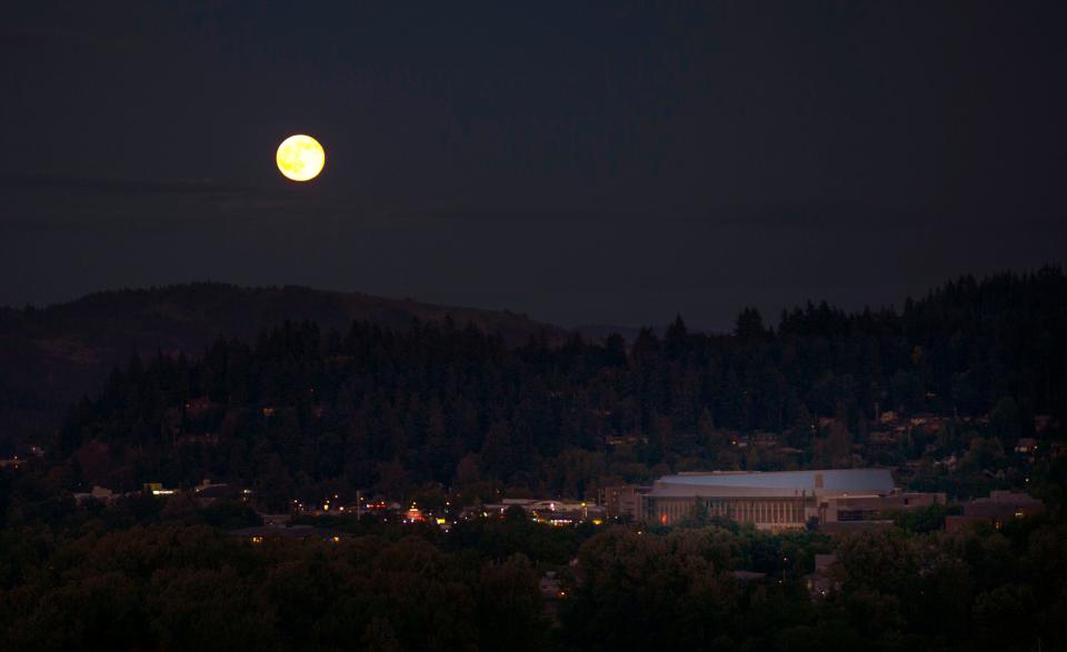 A Strawberry Moon rises east of Eugene over Matthew Knight Arena and Hendricks Park as seen from Skinner Butte in Eugene in 2016. city of Eugene view
