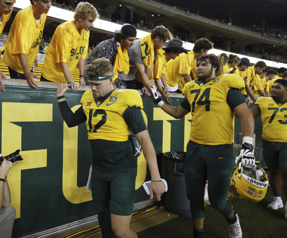 Baylor quarterback Blake Shapen, front left, an lineman Kaden Sieracki shake hands with students following their season opener NCAA college football game against Texas State, Saturday, Sept. 2, 2023, in Waco, Texas. (Rod Aydelotte/Waco Tribune-Herald via AP)