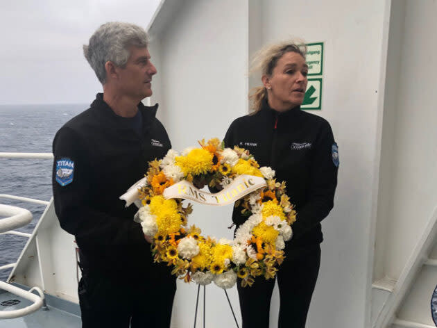 OceanGate CEO Stockton Rush and writer Kim Frank hold a biodegradable memorial wreath that commemorates the lives lost in the sinking of the Titanic. (OceanGate Photo)