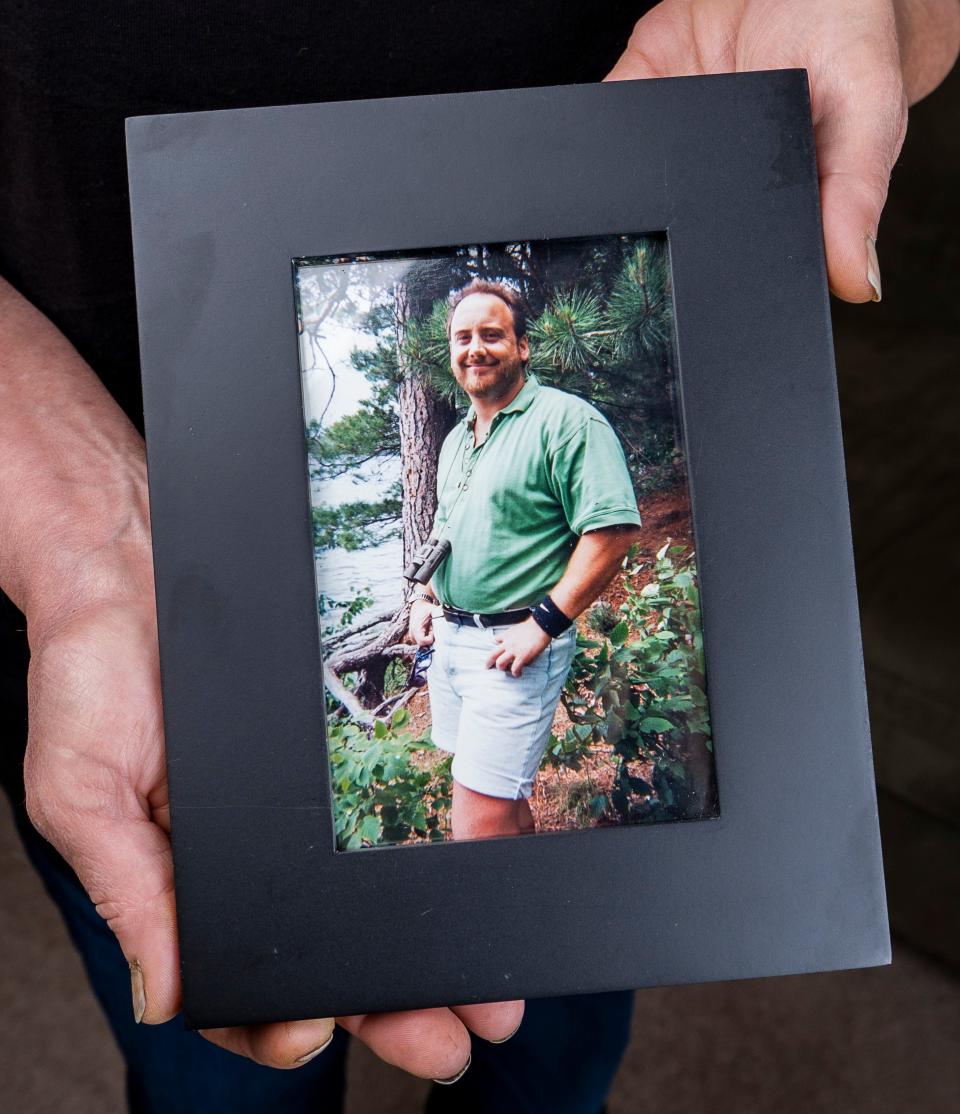 Deborah Hoffmann holds a photo of Dean Hoffmann on Saturday September 9, 2023 in Cedarburg, Wis.