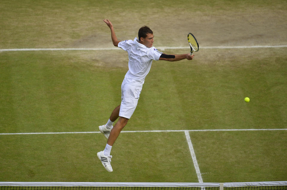 Poland's Jerzy Janowicz in action against Great Britain's Andy Murray during day eleven of the Wimbledon Championships at The All England Lawn Tennis and Croquet Club, Wimbledon.