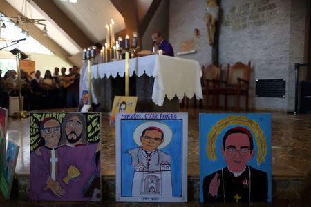 Paintings of slain Salvadoran archbishop Oscar Arnulfo Romero are seen at La Divina Providencia Chapel during a mass in his honour in San Salvador, El Salvador, March 7, 2018. REUTERS/Jose Cabezas