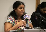 Sunayana Dumala holds her heart while talking about her late husband, Srinivas Kuchibhotla, during a news conference at Garmin Headquarters in Olathe, Kan., Friday, Feb. 24, 2017. Witnesses say a man accused of opening fire in a crowded bar yelled at two Indian men to “get out of my country” before pulling the trigger. The attack killed one of the men and wounded the other, as well as a third man who tried to help. (AP Photo/Orlin Wagner)