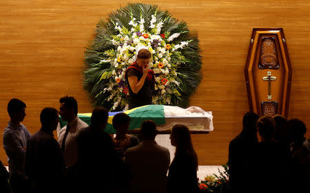 Graca Garbaccio reacts over the coffin of her husband, the former Brazilian soccer player Carlos Alberto, died aged 72 following a heart attack, during his wake at Brazilian Football Confederation (CBF) in Rio de Janeiro, Brazil, October 25, 2016. REUTERS/Ricardo Moraes