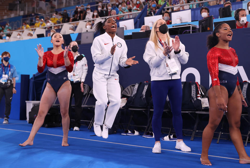 Sunisa Lee, Simone Biles, coach Cecile Landi and Jordan Chiles of Team United States cheer as Grace McCallum competes in floor routine during the Women's Team Final on July 27.<span class="copyright">Laurence Griffiths—Getty Images</span>