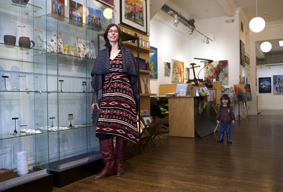 Eden Stein appears with her son Luca, 2, at her gallery Secession Art & Design SF in San Francisco on Jan. 29, 2021. Stein said making art sales during the pandemic has felt a little like a wedding reception: She has reconnected with friends and clients from throughout the gallery’s 13-year history. (Jonathan Koshi via AP)