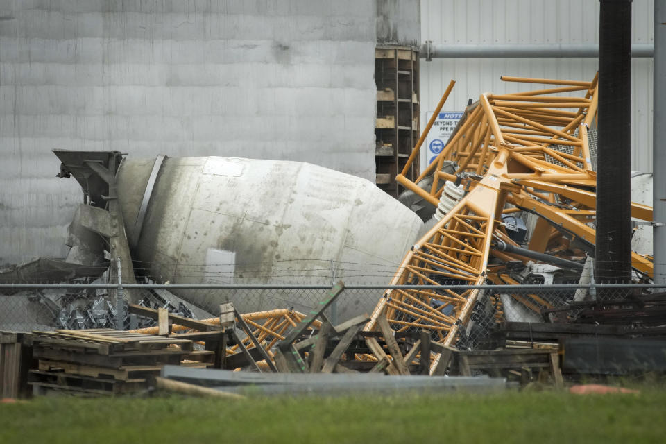 A crane sits on top of a cement truck, Friday, May 17, 2024, in Houston, at an address where authorities say a man was killed when a crane fell on the cement truck he was sitting in during the previous night's storm. (Jon Shapley/Houston Chronicle via AP)