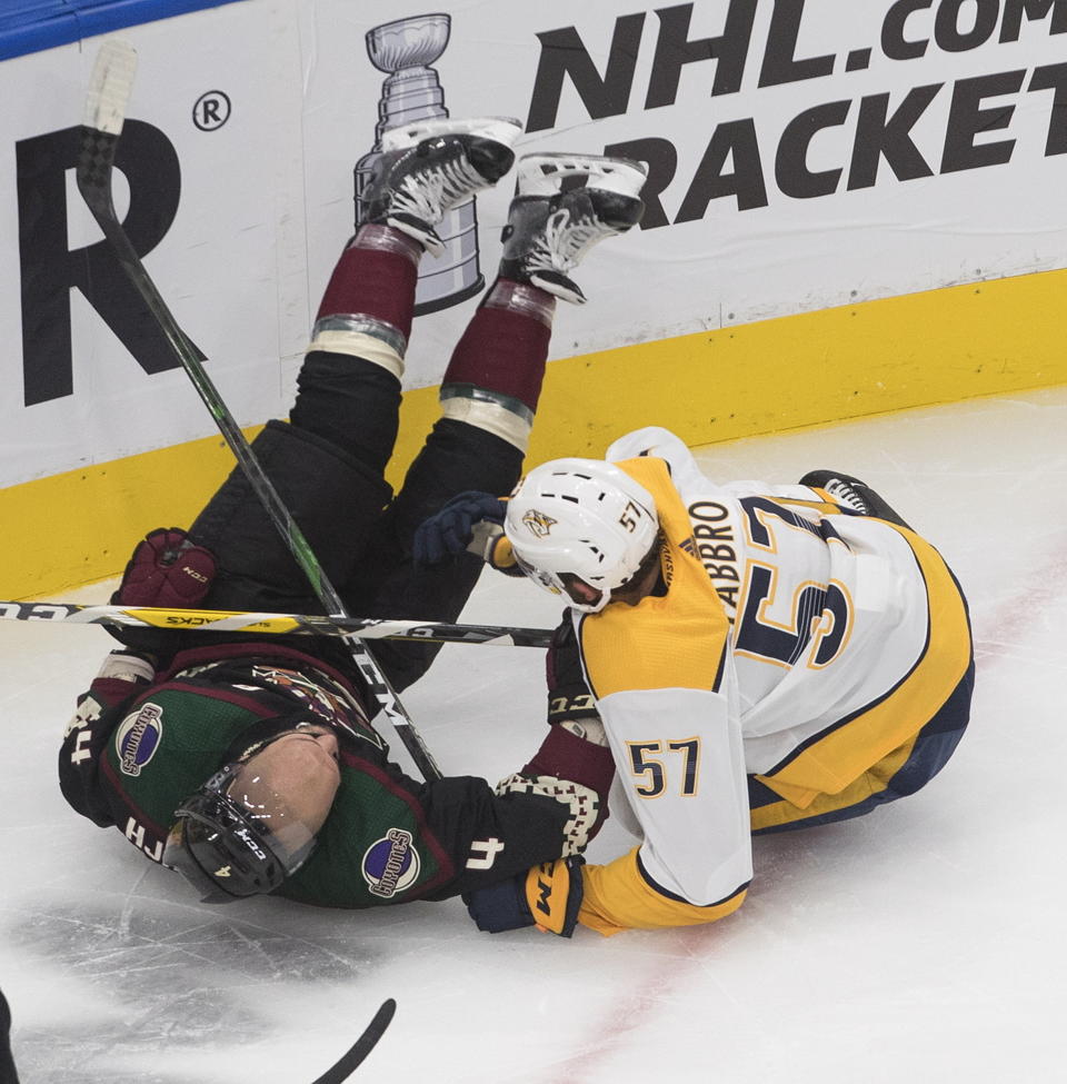 Nashville Predators' Dante Fabbro (57) checks Arizona Coyotes' Niklas Hjalmarsson (4) during first period NHL qualifying round game action in Edmonton, on Wednesday, Aug. 5, 2020. (Jason Franson/The Canadian Press via AP)