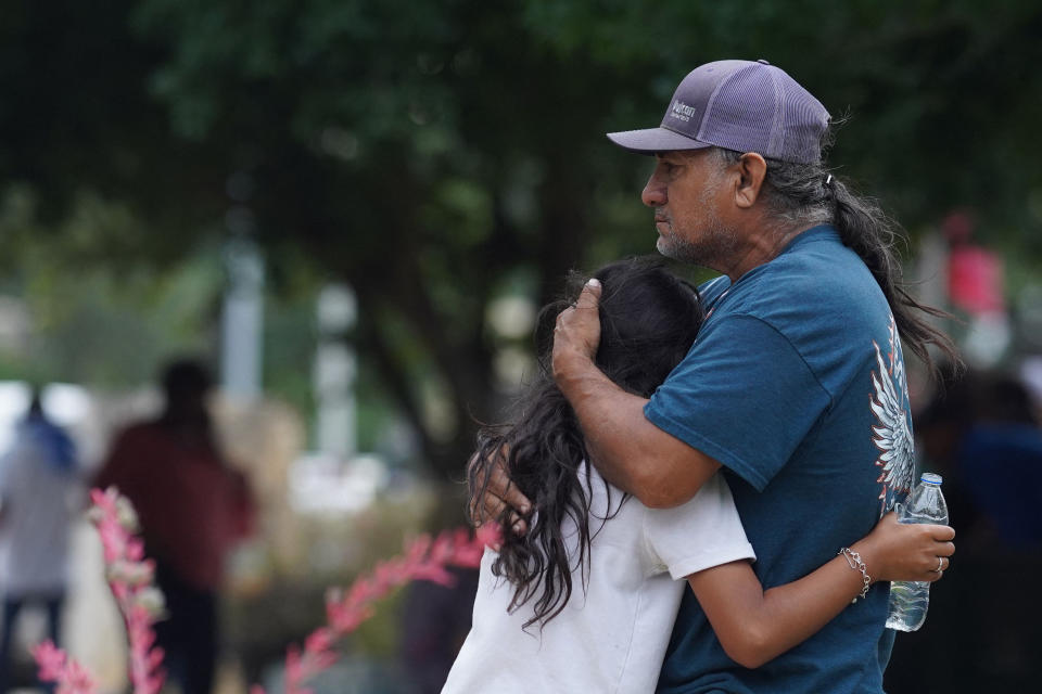 Families hug outside the Willie de Leon Civic Center.