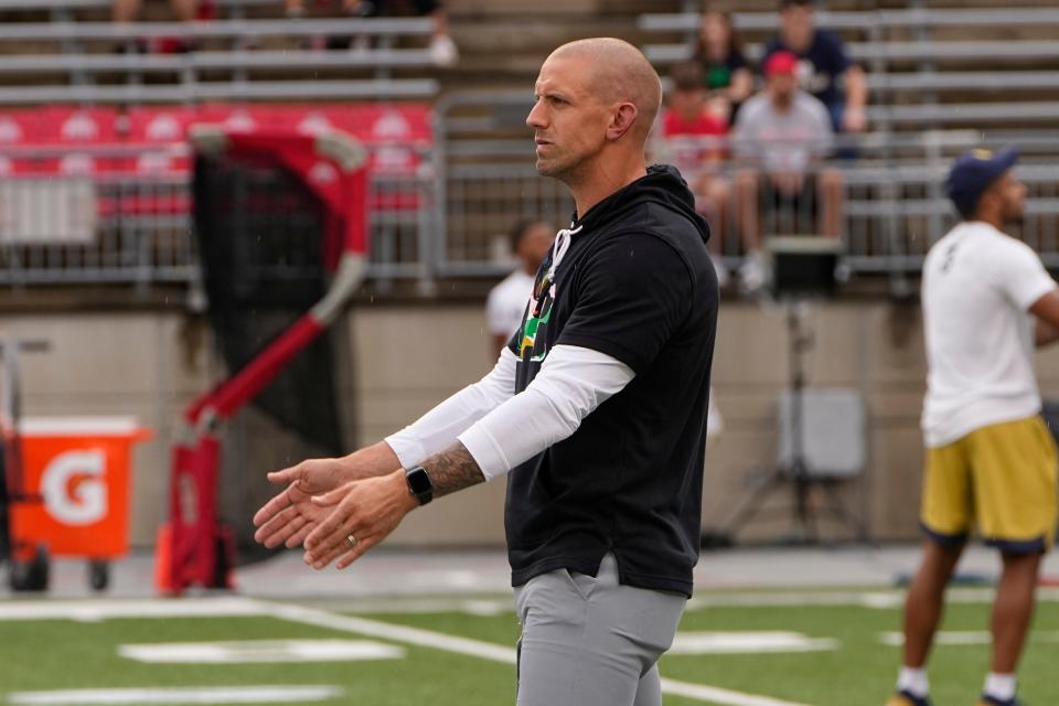 Sep 3, 2022; Columbus, Ohio, USA;  Former Ohio State linebacker James Laurinaitis, now a coach with the Notre Dame Fighting Irish, watches as his team warms up prior to the NCAA football game against the Ohio State Buckeyes at Ohio Stadium. Mandatory Credit: Adam Cairns-USA TODAY Sports