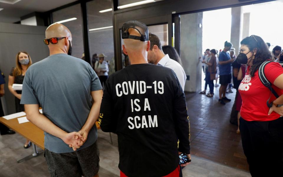 People protest against the school mask mandate, enacted to help slow the spread of COVID-19, outside a Hillsborough County School Board meeting in Tampa, Florida,  - Reuters