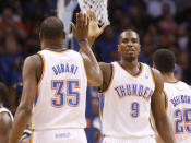 Oklahoma City Thunder forward Serge Ibaka (9) high fives teammate Kevin Durant (35) in the first quarter of an NBA basketball game against the Sacramento Kings in Oklahoma City, Sunday, Jan. 19, 2014. (AP Photo/Sue Ogrocki)