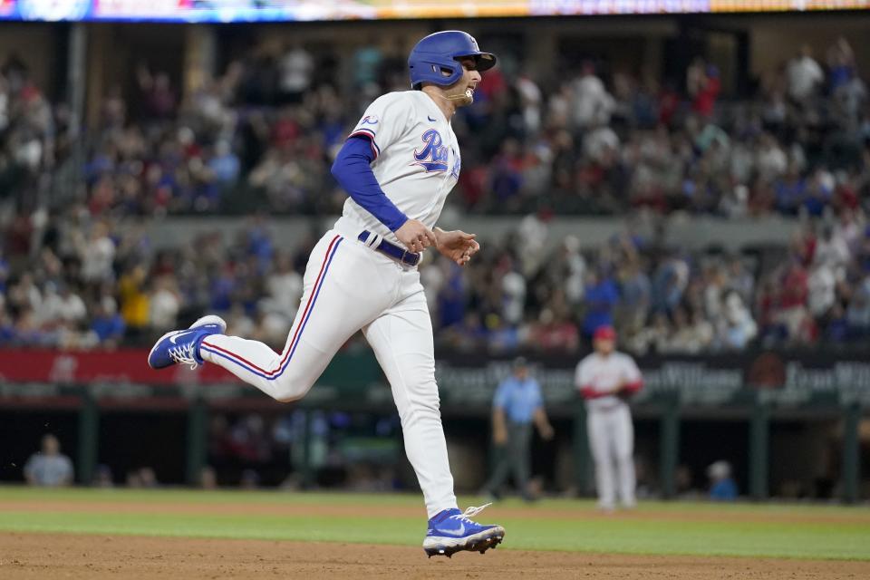 Texas Rangers' Brad Miller runs the bases after hitting a solo home run against the Los Angeles Angels during the seventh inning of a baseball game Wednesday, May 18, 2022, in Arlington, Texas. (AP Photo/Tony Gutierrez)